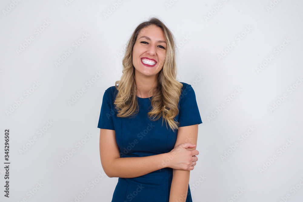 Lovely good-natured young caucasian woman having charming smile and friendly expression holding herself wanting to show her love and sympathy. My heart is for you! Lovely good-natured young caucasian woman having charming smile and friendly expression holding herself wanting to show her love and sympathy. My heart is for you!
