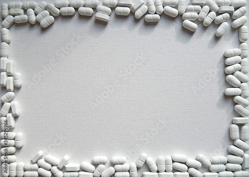  frame of scattered white pills                                 