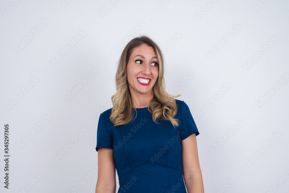 Oops! Portrait of female with specific appearance clenches teeth and looks confusedly aside, realises her bad mistake, poses against copy area for your advertising or promotional background. Oops! Portrait of female with specific appearance clenches teeth and looks confusedly aside, realises her bad mistake, poses against copy area for your advertising or promotional background.