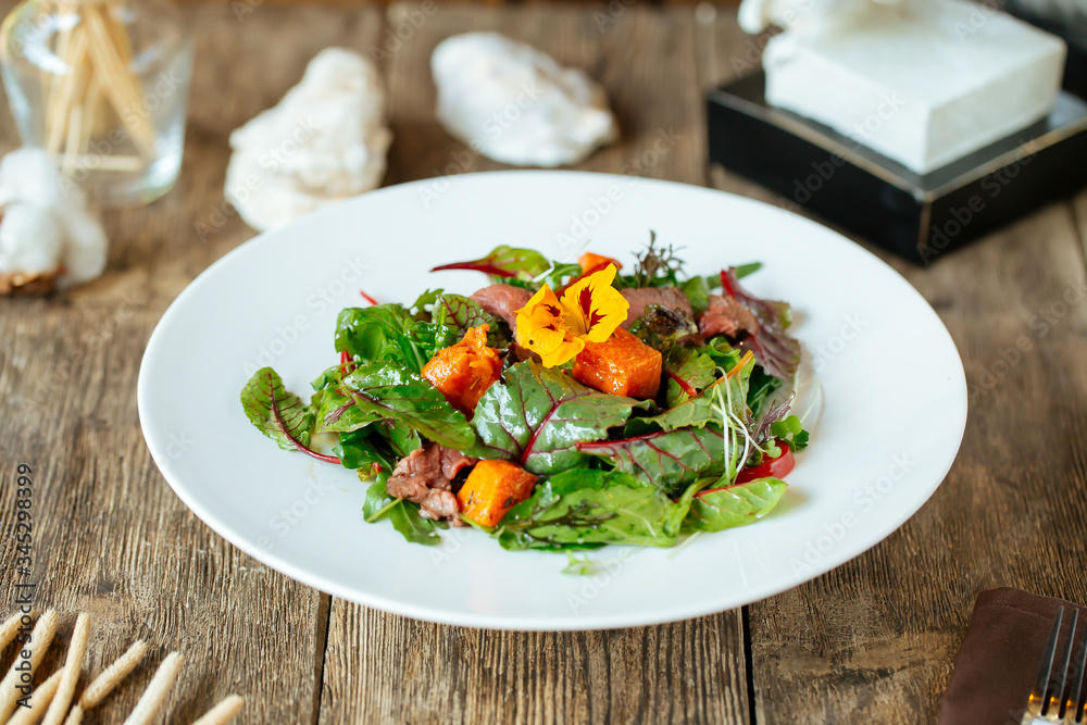 Side view on gourmet salmon and beef meat salad Side view on gourmet salmon and beef meat salad