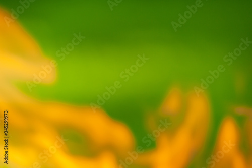 Abstract fire flame on green meadow background. Blur fire flame.
