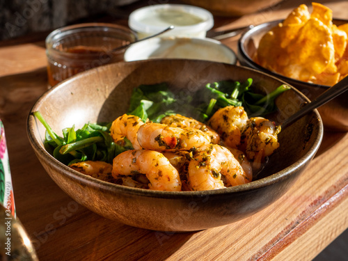 Juicy Chermoula Prawns with spinach together in a bowl. Steaming hot freshly served. 