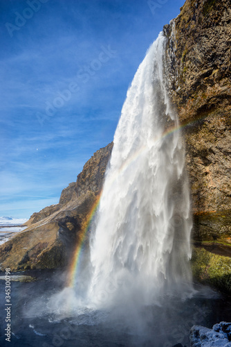 Seljalandsfoss Water on the south coast of Iceland. Blue skies refracting sunlight.