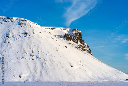 Iceland snow covered mountains with blue sky.