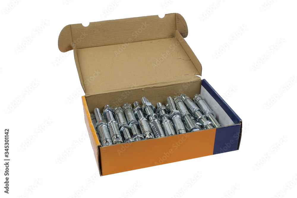 Construction fastening, wedge galvanized anchor in a cardboard carob, isolate on white . Construction fastening, wedge galvanized anchor in a cardboard carob, isolate on white .