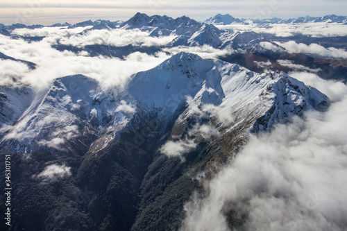 snow covered mountains in the clouds