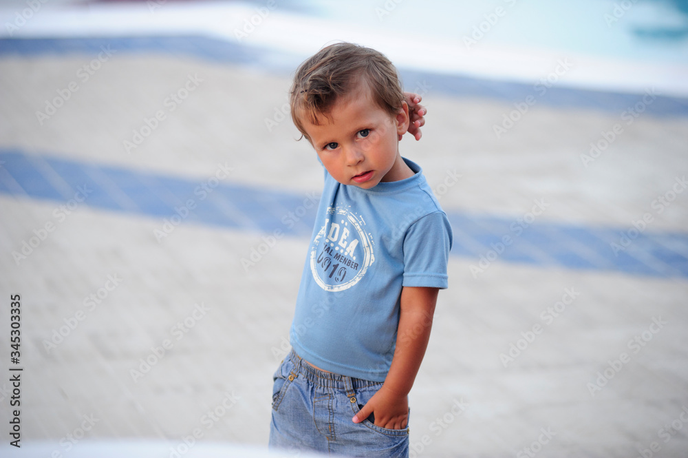 Small European boy poses on the pool. Small European boy poses on the pool.