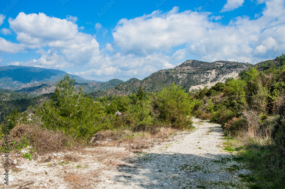 Light clouds cast fancy shadows on the peaks and slopes of the Troodos Mountains. Shadows creep from mountain to mountain, changing their shape. Light clouds cast fancy shadows on the peaks and slopes of the Troodos Mountains. Shadows creep from mountain to mountain, changing their shape.