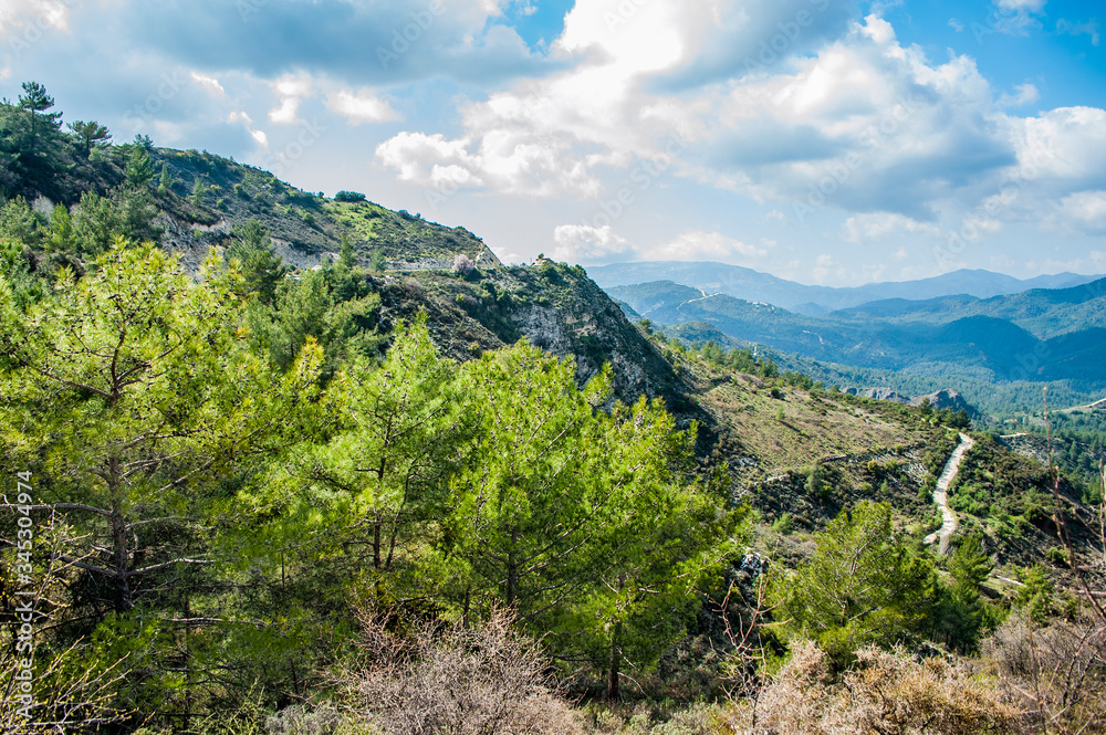 Light clouds cast fancy shadows on the peaks and slopes of the Troodos Mountains. Shadows creep from mountain to mountain, changing their shape.         