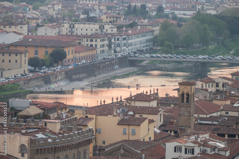 Arno river painted of pink at sunset