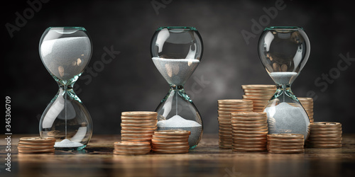 Fotografi Golden coins and hourglass clock