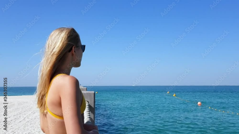 Woman on the beach wind blowing her hair Woman on the beach wind blowing her hair