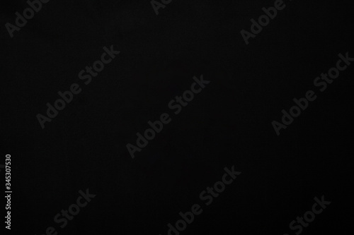 Abstract black fabric texture background. Creases of black color cotton.