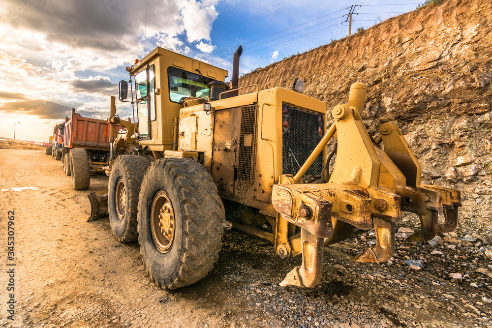 Fototapeta premium Excavator machine leveling the ground with a large shovel