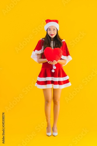 Portrait beautiful young asian christmas clothes and hat smile happy with heart
