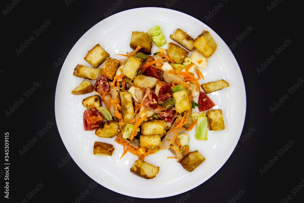 Salad with meat of pig, tomatoes, carrots, cabbage and crackers with bread runner with sauce on the white plate. Healthy and tasty meal for the diet. Delicious breakfast or lunch without GMO Salad with meat of pig, tomatoes, carrots, cabbage and crackers with bread runner with sauce on the white plate. Healthy and tasty meal for the diet. Delicious breakfast or lunch without GMO