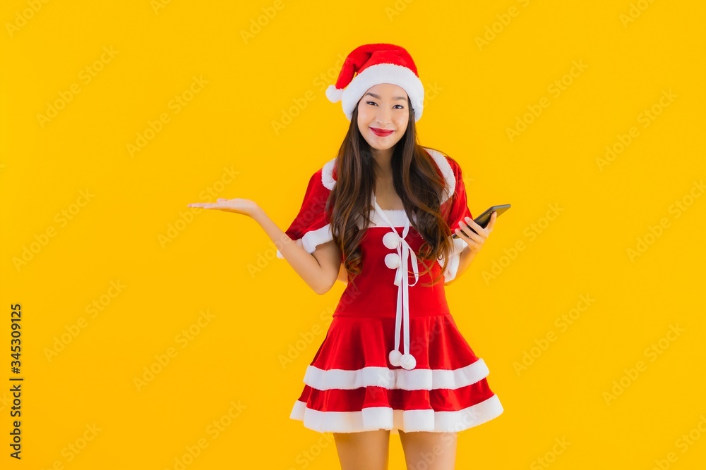 Portrait beautiful young asian woman wear christmas clothes and hat use mobile phone