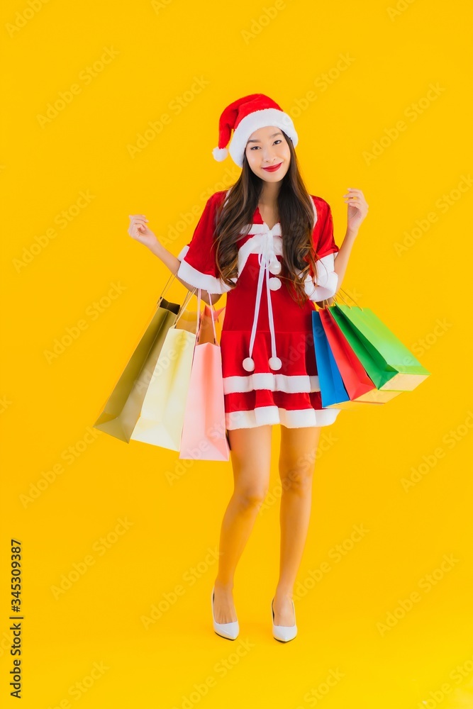Portrait beautiful young asian woman wear christmas clothes hat with a lot of shopping bag