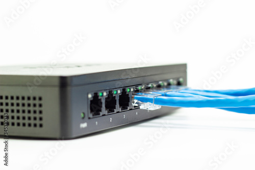 The blue network cables connect port switch on white table concept internet network connection