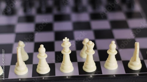 A child places chess on a chessboard. Mental development of children