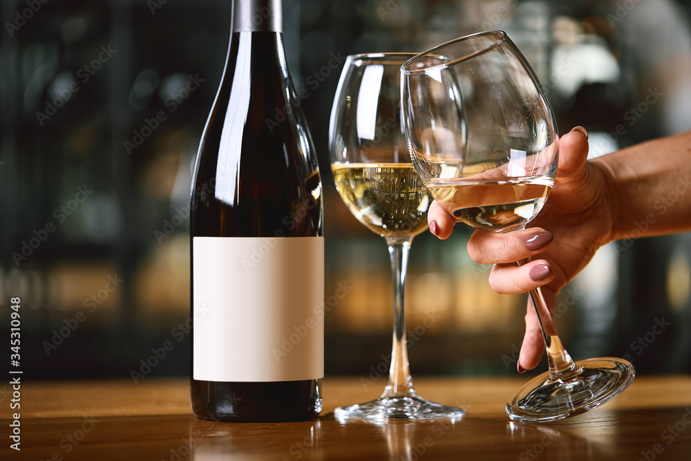 Serving with glasses of wine and a bottle on the table, hands raise a glass of wine, Concept of drinking wine. Copy space