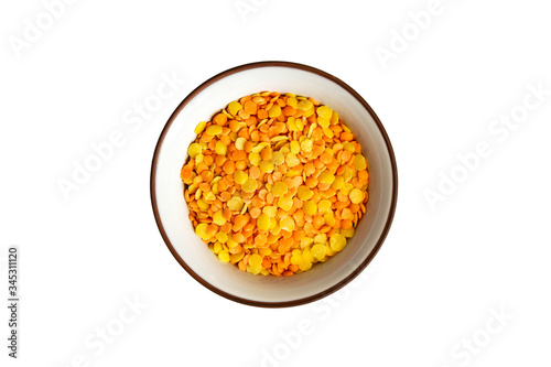 Yellow lentils in bowl isolated on white background