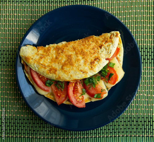 Oatmeal with tomatoes, cheese and herbs on a plate
