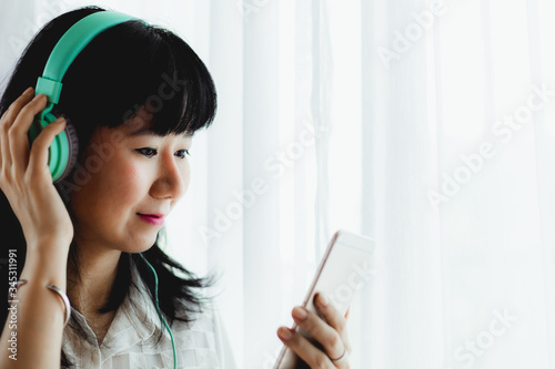 Asian smiling woman wearing...