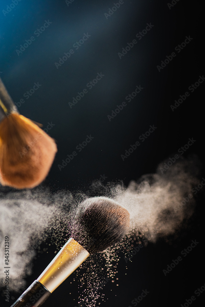 The art of visage. Horizontal closeup photo of two professional black makeup  brushes with colored powder isolated on black background Stock Photo |  Adobe Stock