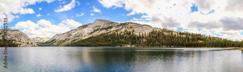 Landscape with lake and reflection of rocky coast at Yosemite National Park, USA, Panorama