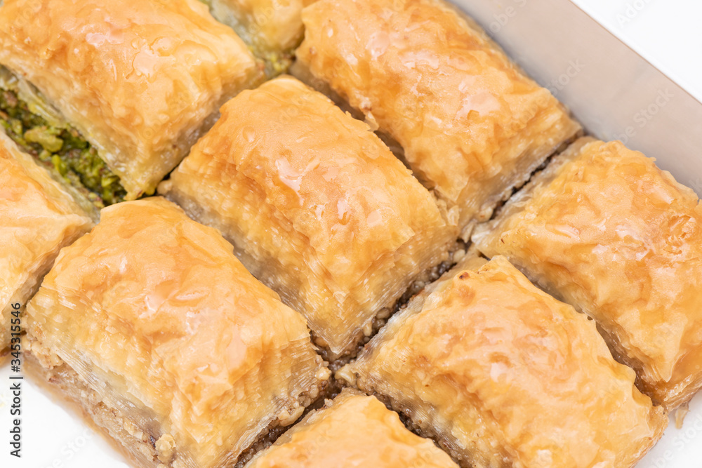 Turkish Ramadan Dessert Baklava isolated on beige plate. Turkish Ramadan Dessert Baklava isolated on beige plate.