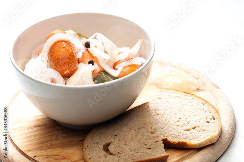 homemade pickled sausages with onion and bread photo