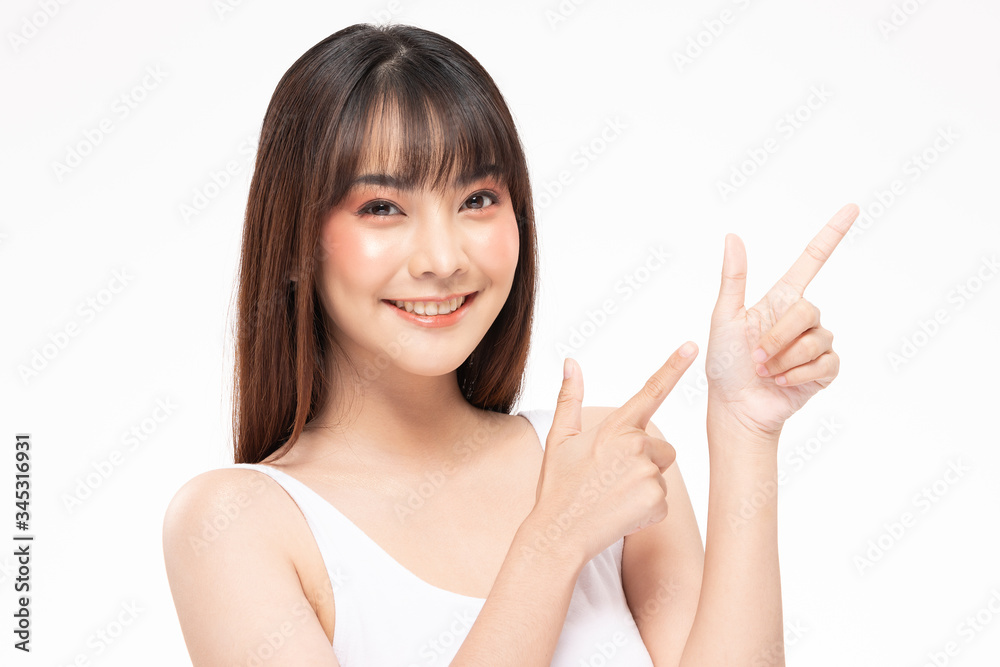 Beautiful Attractive Asian young women smile and pointing to copy space for display Cosmetics product feeling happiness with Healthy Clean and Fresh Skin,Isolated on white background,Beauty Concept Beautiful Attractive Asian young women smile and pointing to copy space for display Cosmetics product feeling happiness with Healthy Clean and Fresh Skin,Isolated on white background,Beauty Concept