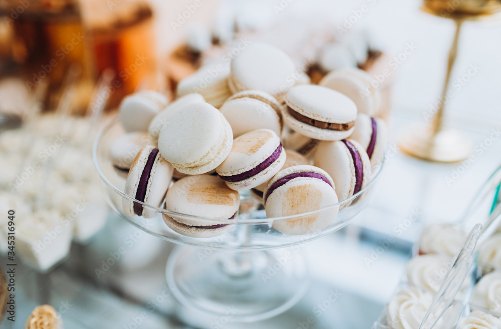 Macarons with chocolate. Sweet table with macaroons. Candy bar or dessert table with macarons and other sweets. Macarons with chocolate. Sweet table with macaroons. Candy bar or dessert table with macarons and other sweets.