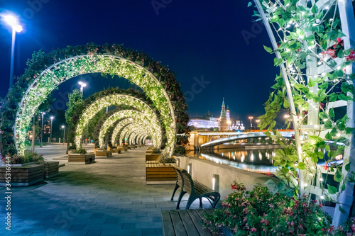 Moscow. Russia. Flower arches on the shore of the Kremlin embankment. Decoration of Moscow at night. Flowers on the evening promenade. Flower arches glow at night. Vacations in Russia.
