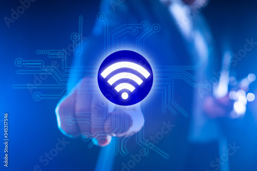 Using WiFi to transfer data. Concept - setting up WiFi equipment for office. Telecommunication services. Man clicks on the WiFi logo. Concept - company provides Internet configuration services