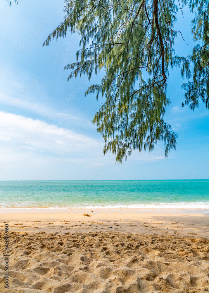 View from tropical beach at Koh Lanta island, Thailand. View to pure sea with boats and yacht on water. Look from shadow of tree on sand beach. Summer paradise, vibrant colors, tropical exotic place