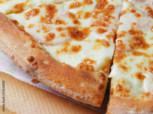 close up view of a ham and cheese pizza. Delicious and nutritious dish from Italy