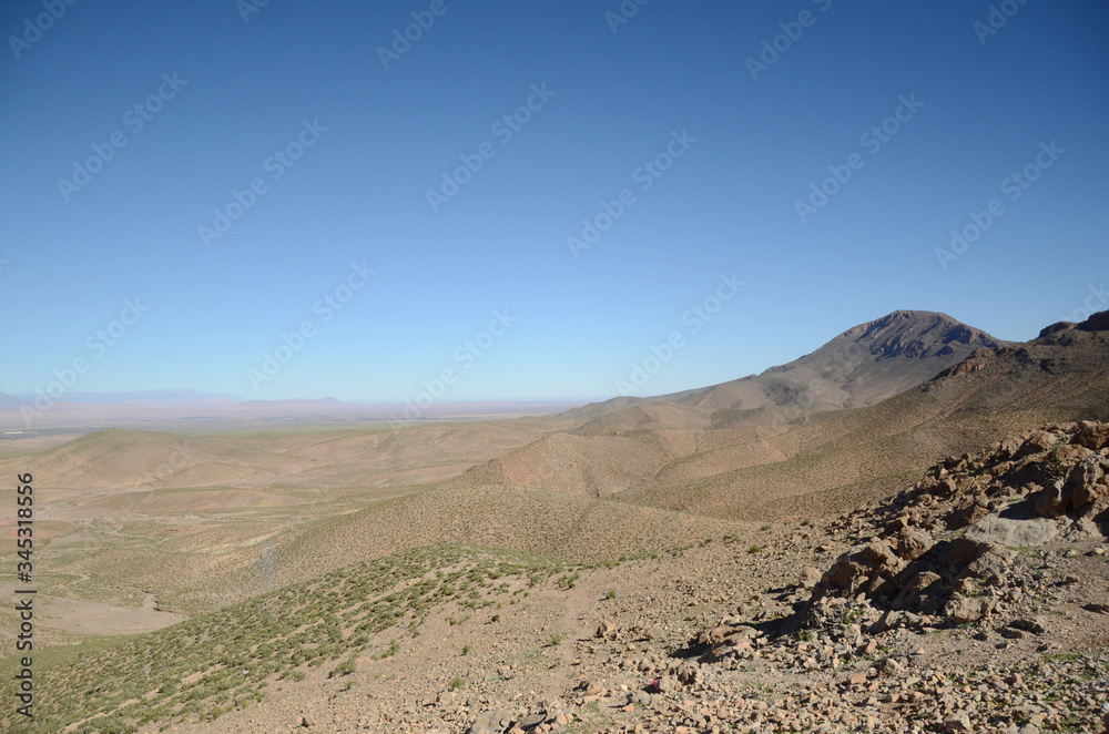 Curly road between the mountains in Ziz Gorges, Morocco, on a blue day. The journey from Fes to Merzouga desert.