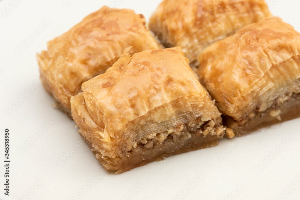 Turkish Ramadan Dessert Baklava isolated on beige plate. Turkish Ramadan Dessert Baklava isolated on beige plate.