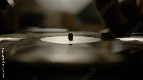 Putting vinyl record on turntable and putting stylus needle on
