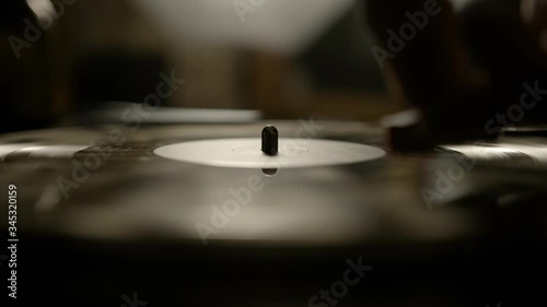 Putting vinyl record on turntable and putting stylus needle on