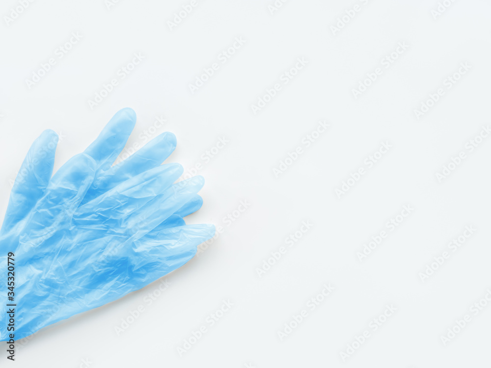 Top view on pack of blue medical protective rubber gloves. Precaution of coronavirus COVID-19 concept on white background with copy space.