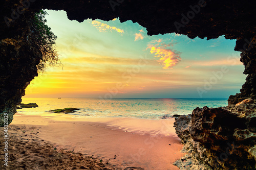 Amazing view on tropical beach from mountain cave at sunset