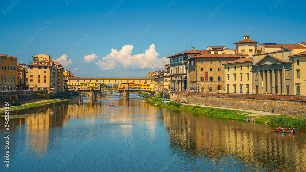 Beautiful wide angle view on Ponte del Vecchio and Arno river in Florence, Italy at summer's noon