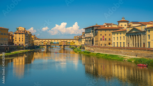 Beautiful wide angle view on Ponte del Vecchio and Arno river in Florence, Italy at summer's noon © MKozloff
