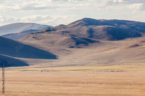 the mongolian kazakhs of western mongolia migrate each year with their herd of camels. horses, sheep, cows and goats in the snowy altai mountain, from camp to camp.