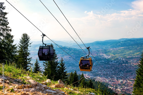 View from the top of the mountain on the city of Sarajevo and funiculars rising up to the highest point of the city.