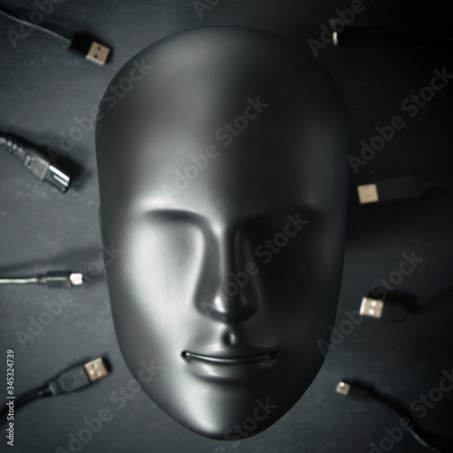 Inorganic human robot android face ready to connect with many digital device wires cables chargers. Digitalization, chipization, artificial intelligence, futuristic cyborg concept in total black color photo