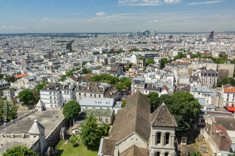 PARIS, FRANCE - JUNE 23, 2016: Aerial view of church of Saint Pierre de Montmartre from Basilica of the Sacred Heart of Jesus stands at the summit of the butte Montmartre - highest point in the Paris